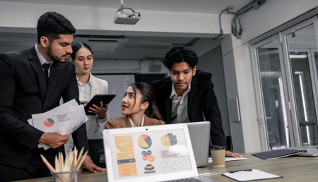 Financial advisors collaborate to assess a company's financial performance using data from its operational activities. Team members work together in a discussions meeting to develop a business plan.の写真素材