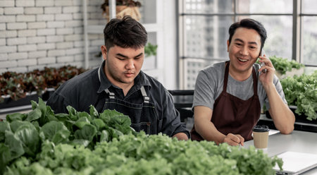 The vegetable seller celebrated with his staff on receiving a large number of orders via phone. This has the potential to generate high income and provide opportunity to upsell additional products.の写真素材