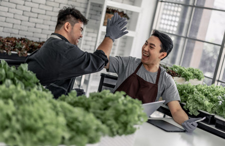 The vegetable seller celebrated with his staff on receiving a large number of orders via phone. This has the potential to generate high income and provide opportunity to upsell additional products.の写真素材