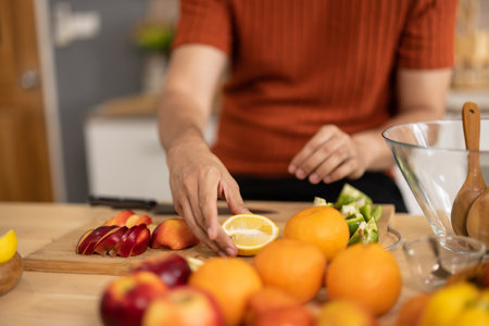 A homely and healthy male prepares nutritious diet, including variety of fruits. Following cooking...