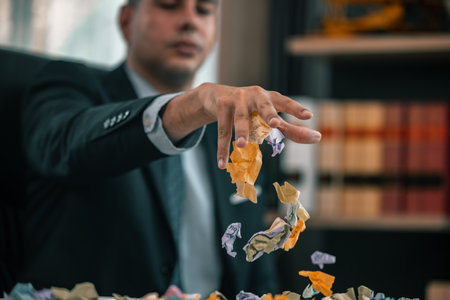 After having difficulties with project's actual implementation, designers feel stress and concern, which causes them to angrily crumple some sticky notes, that contained a number of different ideas.の写真素材
