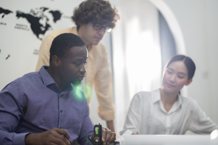 Architect and interior designer collaborate on a low carbon building master plan, using precision tools to measure, mark dimensions, and create a detailed mock-up model for LEED certification approvalの写真素材