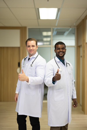 Group of diverse, experienced doctors from different of filed gathering as primary healthcare team. Creating positive relationships with colleagues. Smiling, sharing ideas the during break.の写真素材