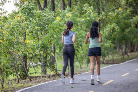 Fashionable female runners dressed in modern gear, finds peace in rhythmic beats. Recharge energy in...
