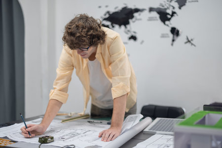 Multicultural team of architects collaborates on a low-carbon building project, analyzing...