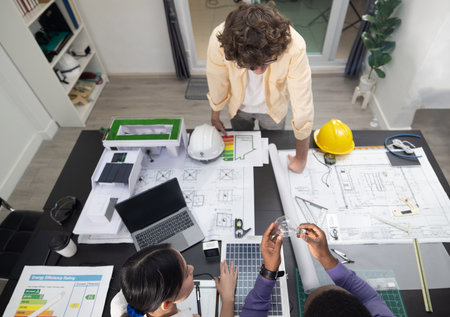 Team of architects planning sustainable, low CO2 emission buildings with innovative green technology...