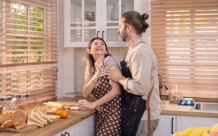 Cheerful scene in sunny kitchen with lively atmosphere where couple is having playful interaction...