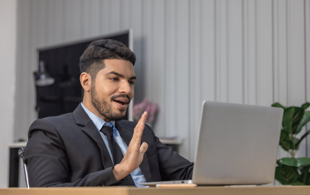 Professional businessperson in a suit is deeply focused on laptop in a modern office. Concentration and seriousness for corporate work environments and business decision-making scenarios.の写真素材