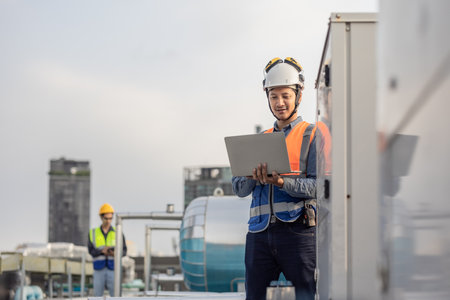 Professional industrial engineer, equipped with a laptop, meticulously troubleshooting an HVAC...