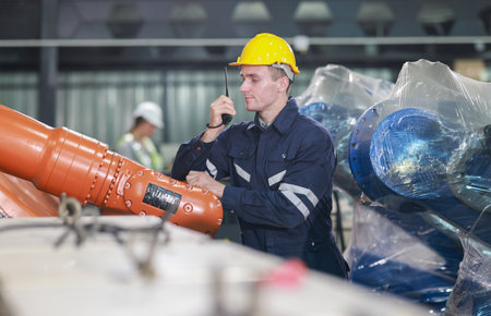 Robotic engineers conducting quality control and maintenance by examining, testing, and repairing...