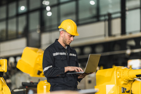 Robotic engineer monitor performance of software and computer-controlled machine tools. Troubleshooting, upgrading existing program to make them more efficient.の写真素材