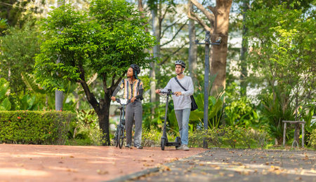 Young people commuting to work using eco-friendly transportation including electric scooters and folding bicycles, encouraging environmentally conscious and sustainable transportation.の写真素材