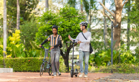 Young people commuting to work using eco-friendly transportation including electric scooters and...