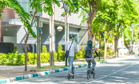 Young people commuting to work using eco-friendly transportation including electric scooters and...