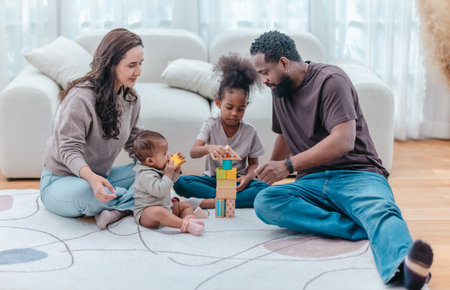 Heartwarming scene of diverse family spending quality time together in living room. The group includes parents and two children, showcasing love, connection, togetherness in modern family settingの写真素材