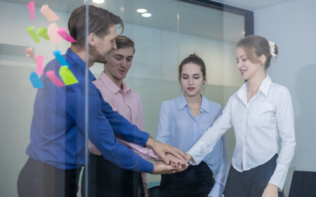 Group of professionals in office celebrating with applause and smiles. Positive atmosphere reflects teamwork, motivation, success, highlighting collaboration and workplace appreciation.の写真素材