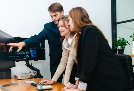 Financial analyst working on multiple monitors displaying stock market charts, financial data, and...