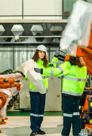 Engineer analyze blueprint in robotic facility to monitor carbon footprint and optimize emissions...