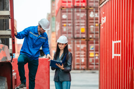 Industrial container workers discussing eco-friendly logistics strategies. Reducing fuel...