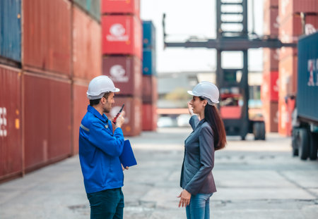 Industrial container workers discussing eco-friendly logistics strategies. Reducing fuel...