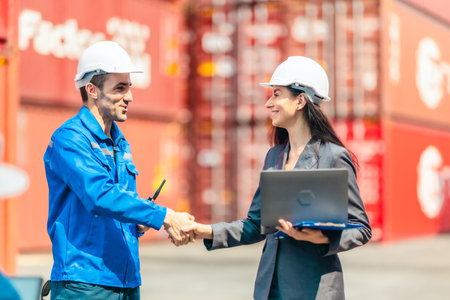 Industrial container workers discussing logistics strategies. Reducing fuel consumption, lowering...