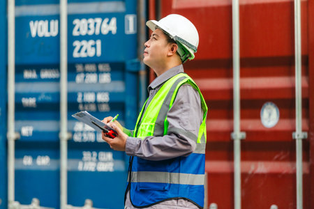 Industrial workers conducting container inspections inside a shipping facility. Reviewing documents...