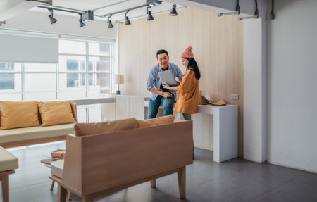 Two business partners evaluate various sustainable packaging materials in modern workspace. Highlighting creative collaboration, product design, and environmentally conscious business practices.の写真素材