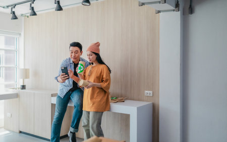 Two business partners evaluate various sustainable packaging materials in modern workspace. Highlighting creative collaboration, product design, and environmentally conscious business practices.の写真素材