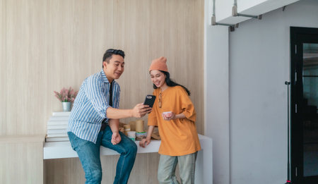 Two business partners evaluate various sustainable packaging materials in modern workspace. Highlighting creative collaboration, product design, and environmentally conscious business practices.の写真素材