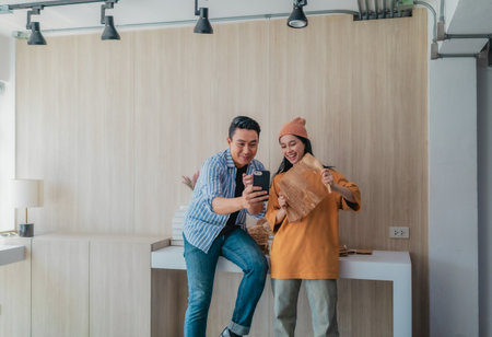 Two business partners evaluate various sustainable packaging materials in modern workspace. Highlighting creative collaboration, product design, and environmentally conscious business practices.の写真素材