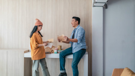 Two business partners evaluate various sustainable packaging materials in modern workspace. Highlighting creative collaboration, product design, and environmentally conscious business practices.の写真素材