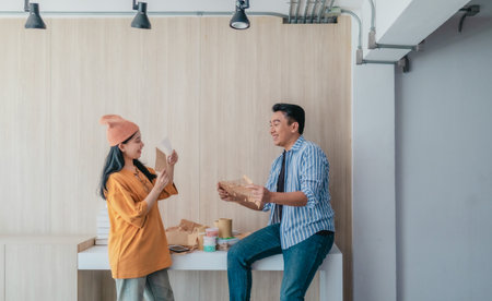 Two business partners evaluate various sustainable packaging materials in modern workspace....