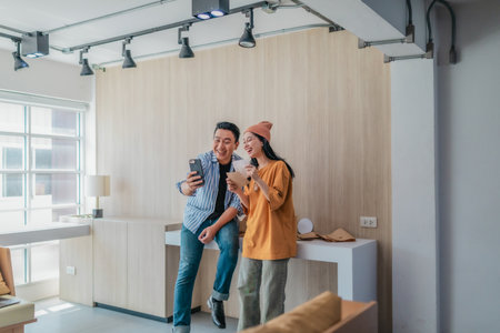 Two business partners evaluate various sustainable packaging materials in modern workspace. Highlighting creative collaboration, product design, and environmentally conscious business practices.の写真素材