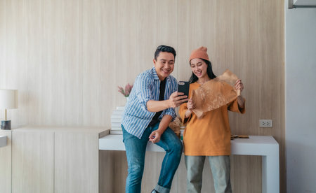 Two business partners evaluate various sustainable packaging materials in modern workspace. Highlighting creative collaboration, product design, and environmentally conscious business practices.の写真素材