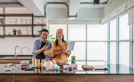 Two entrepreneurs review sustainable packaging samples in a modern workspace. Surrounded by eco-friendly materials and product prototypes, they discuss ideas for product development and brandingの写真素材