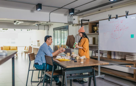 Creative startup team brainstorming innovative and eco-friendly packaging solutions. Reflecting...