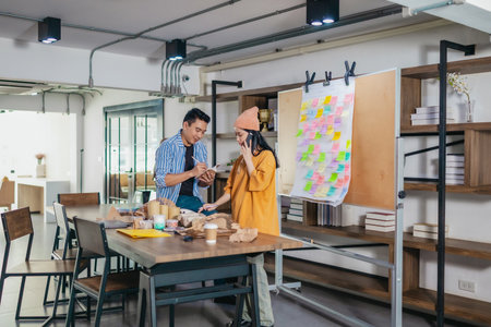 Startup team collaborates using Agile-style task board  to organize, plan, track the development of...