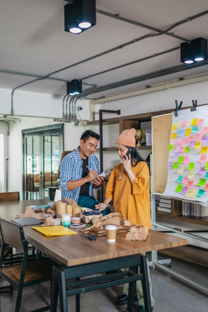 Startup team collaborates using Agile-style task board  to organize, plan, track the development of...