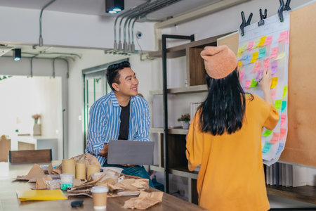 Startup team collaborates using Agile-style task board  to organize, plan, track the development of...