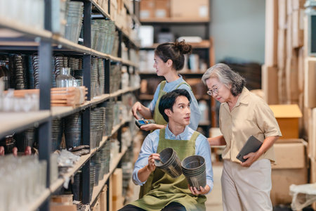 Mother and owner educates her children in family business warehouse. Material selection, product quality, sustainable recycling practices to improve production efficiency and eco friendly operationsの写真素材
