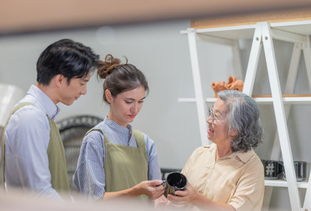 Mother and owner educates her children in family business warehouse. Material selection, product quality, sustainable recycling practices to improve production efficiency and eco friendly operationsの写真素材