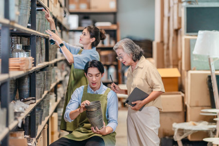 Mother and owner educates her children in family business warehouse. Material selection, product quality, sustainable recycling practices to improve production efficiency and eco friendly operationsの写真素材