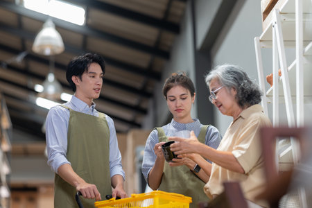 Mother and owner educates her children in family business warehouse. Material selection, product quality, sustainable recycling practices to improve production efficiency and eco friendly operationsの写真素材