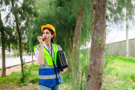 Female environmental engineer conducts field survey in pine forest, measuring, documenting tree...