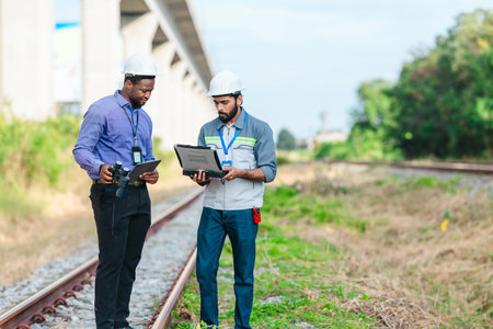 Engineer presents railway development proposal to investor during site visit, discussing green...