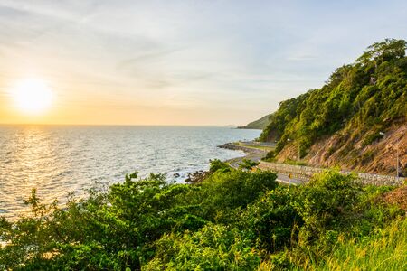 A scenery of road beside mountains and sea with the sunset time in Chanthaburi Thailand.の写真素材