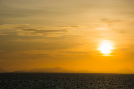 Sunset at the sea with the orange sky and partly cloud sky in Chanthaburi, Thailand.の写真素材