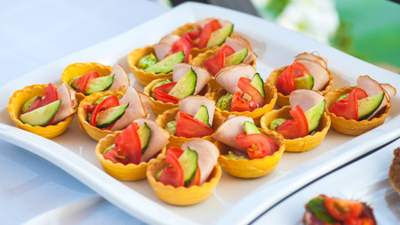 Plate with food for stand-up meal on the table