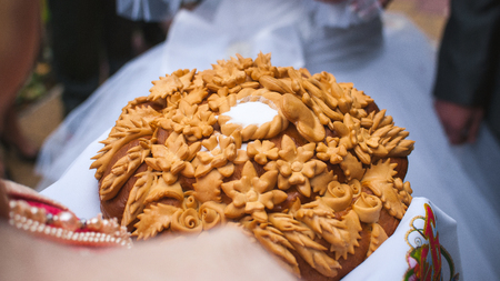 Wedding round loaf with salt presented bride and groom. It's Slavic national traditionの写真素材