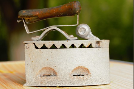 Old clothes iron, work with coalsの写真素材